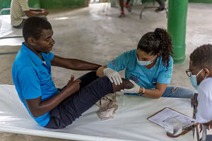 Consuelo accompagne un patient dans une rotation d’équipe mobile après son amputation suite au tremblement de terre d'août 2021 en Haïti