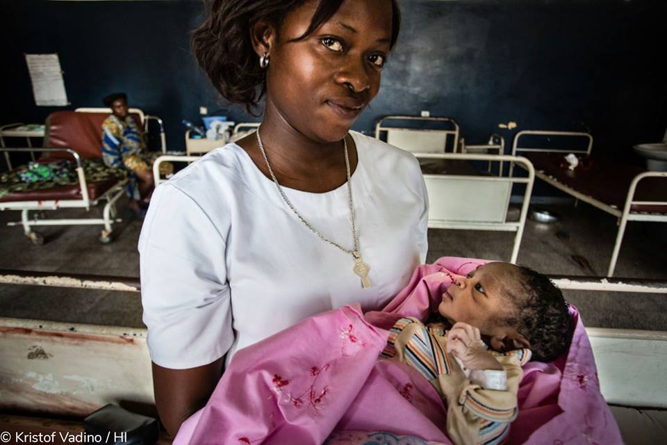 Une mère tient son enfant dans les bras 