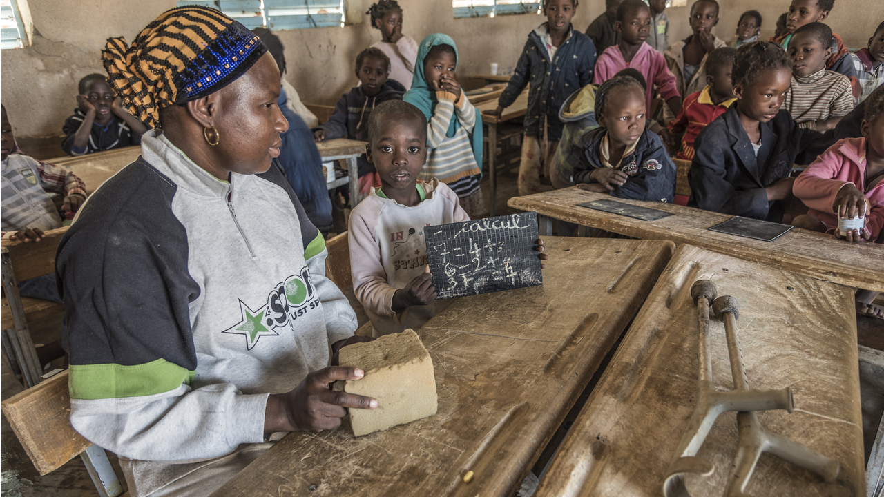 Abdoul Samadou, 7, with a visiting Pedagogical Advisor